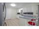 Updated kitchen with white cabinets, stainless steel appliances, and breakfast bar with seating at 4810 County Road 114, Wildwood, FL 34785