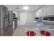 Stainless steel refrigerator and appliances highlight this kitchen with breakfast bar and overhead lighting at 4810 County Road 114, Wildwood, FL 34785