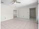 Spacious living room with tile flooring, neutral walls, ceiling fan, and easy access to other rooms at 4810 County Road 114, Wildwood, FL 34785