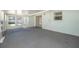 Spacious sunroom with gray carpeting, surrounded by windows for natural light at 4810 County Road 114, Wildwood, FL 34785