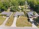 Aerial view of a well-maintained home featuring a long driveway and lush green lawn at 5591 Nw 57Th Pl, Ocala, FL 34482
