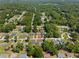 Wide aerial view of a home, nestled in a neighborhood with mature trees at 5591 Nw 57Th Pl, Ocala, FL 34482