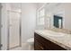 Bathroom features a walk-in shower with glass door and a vanity with granite countertop at 5591 Nw 57Th Pl, Ocala, FL 34482
