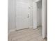 Foyer showcasing neutral-toned tile flooring, a coat closet with an open door, and the front door at 5591 Nw 57Th Pl, Ocala, FL 34482