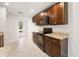 Stylish kitchen featuring granite countertops, dark wood cabinetry, and modern appliances at 5591 Nw 57Th Pl, Ocala, FL 34482