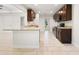 Modern kitchen with granite countertops, brown cabinets, and stainless steel appliances at 5591 Nw 57Th Pl, Ocala, FL 34482