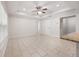 Bright living room with neutral-toned tile flooring, recessed lighting, and a ceiling fan at 5591 Nw 57Th Pl, Ocala, FL 34482