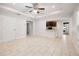 Living room featuring neutral-toned tile flooring, recessed lighting, and a breakfast bar with dark wood cabinets at 5591 Nw 57Th Pl, Ocala, FL 34482