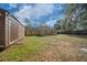 The large backyard features a wooden storage shed and fire pit at 5900 Nw 61St Ct, Ocala, FL 34482