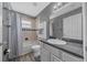 Well-lit bathroom with tub-shower combo and white vanity with hard surface counters at 5900 Nw 61St Ct, Ocala, FL 34482
