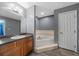 Bathroom with tub, vanity, and wood-look flooring at 5900 Nw 61St Ct, Ocala, FL 34482