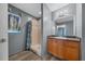 Bathroom features a shower, wooden vanity, framed mirror and decorative shower and window curtains at 5900 Nw 61St Ct, Ocala, FL 34482