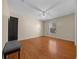 Bedroom featuring wood floors, neutral walls, a ceiling fan and a large window at 5900 Nw 61St Ct, Ocala, FL 34482