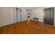 Bedroom featuring wood floors, neutral walls, closet, and a dark wood wardrobe at 5900 Nw 61St Ct, Ocala, FL 34482