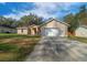 Charming single-Gathering home featuring a manicured lawn and an attached two-car garage at 5900 Nw 61St Ct, Ocala, FL 34482