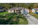 Charming single-Gathering home featuring a manicured lawn and an attached two-car garage at 5900 Nw 61St Ct, Ocala, FL 34482