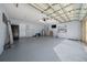 Spacious garage with storage shelves and visible garage door mechanics for easy maintenance at 5900 Nw 61St Ct, Ocala, FL 34482