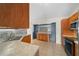 Kitchen featuring stainless steel appliances, wood cabinets, tile backsplash, and marble countertops at 5900 Nw 61St Ct, Ocala, FL 34482