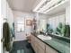 Bathroom with green countertops, a large mirror, and a shower with a tropical-themed curtain at 6150 Nw 59Th Ave, Ocala, FL 34482
