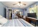 Bedroom featuring blue walls, a mirrored closet, and a wooden desk with a TV at 6150 Nw 59Th Ave, Ocala, FL 34482