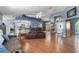 Open living room with wood floors and lots of natural light at 6150 Nw 59Th Ave, Ocala, FL 34482