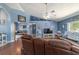 Spacious living room with a vaulted ceiling, neutral paint, and cozy leather furniture at 6150 Nw 59Th Ave, Ocala, FL 34482