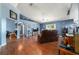 Bright living room featuring hardwood floors, vaulted ceilings, and an airy atmosphere at 6150 Nw 59Th Ave, Ocala, FL 34482