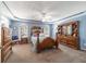 Comfortable main bedroom with a tray ceiling and arched windows at 6150 Nw 59Th Ave, Ocala, FL 34482