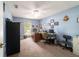 Office space featuring light blue walls, a ceiling fan, and a desk with office chairs at 6150 Nw 59Th Ave, Ocala, FL 34482