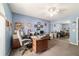 Office featuring blue walls, a ceiling fan, a large desk, and ample storage space at 6150 Nw 59Th Ave, Ocala, FL 34482