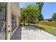 Exterior patio area with a view of the landscaped yard and a section of a wooden fence at 6150 Nw 59Th Ave, Ocala, FL 34482