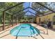 Inviting screened-in pool area, perfect for relaxing and entertaining in a private backyard setting at 6150 Nw 59Th Ave, Ocala, FL 34482