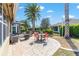 Expansive outdoor patio with lush landscaping, ideal for outdoor gatherings, with tables and chairs to enjoy the view at 7167 Sw 99Th Cir, Ocala, FL 34481