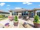 Outdoor patio with multiple seating arrangements and well-maintained landscaping provides a relaxing outdoor living space at 7167 Sw 99Th Cir, Ocala, FL 34481
