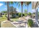 A well-maintained backyard featuring a stone patio, lush green lawn, and mature trees at 7167 Sw 99Th Cir, Ocala, FL 34481