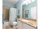 Bathroom featuring a tub/shower combination, granite countertop vanity, and neutral decor at 7167 Sw 99Th Cir, Ocala, FL 34481