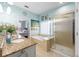 This primary bathroom features granite counters, dual sinks, a soaking tub, and glass enclosed shower at 7167 Sw 99Th Cir, Ocala, FL 34481