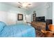 This cozy bedroom features wood floors, ceiling fan and neutral paint for a peaceful space at 7167 Sw 99Th Cir, Ocala, FL 34481