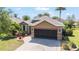 Attractive home showcasing a well-maintained exterior, nicely landscaped front yard, and a two-car garage at 7167 Sw 99Th Cir, Ocala, FL 34481