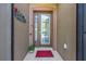 Charming front door with decorative glass, sidelights, and a cheerful red welcome mat at 7167 Sw 99Th Cir, Ocala, FL 34481