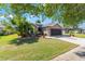 Charming home featuring a well-manicured lawn, mature landscaping, and a welcoming entrance at 7167 Sw 99Th Cir, Ocala, FL 34481