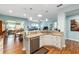 Open concept kitchen with granite counters and stainless dishwasher flows into dining and living areas at 7167 Sw 99Th Cir, Ocala, FL 34481