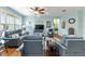 Cozy living room features a ceiling fan, comfortable seating, and decoratively adorned walls at 7167 Sw 99Th Cir, Ocala, FL 34481