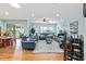 Spacious living room with comfortable leather seating, ceiling fan, and a view of the outdoor patio at 7167 Sw 99Th Cir, Ocala, FL 34481