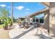 A covered patio area with comfortable seating, ideal for outdoor dining and relaxation, with landscaped perimeter at 7167 Sw 99Th Cir, Ocala, FL 34481