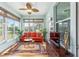 Inviting sunroom with large windows, comfortable seating, and stylish decor, perfect for relaxation and entertaining at 7167 Sw 99Th Cir, Ocala, FL 34481