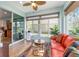 Inviting sunroom with sliding glass door and large windows, comfortable seating, and stylish decor, creating an open, relaxing space at 7167 Sw 99Th Cir, Ocala, FL 34481