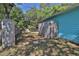 Backyard view shows the side of a blue home and a new fence line at 731 Cloverleaf Blvd, Deltona, FL 32725