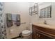 Cozy bathroom with a single vanity, toilet, grab bars, and decorative mirror at 731 Cloverleaf Blvd, Deltona, FL 32725
