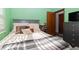 Bright bedroom with a grey bedframe and bright green walls at 731 Cloverleaf Blvd, Deltona, FL 32725